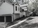 Charming home with a detached garage, lush landscaping, and a welcoming entrance at 760 Swan Ln, Canton, GA 30115