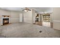 Spacious living room featuring a fireplace and plush carpeting flowing seamlessly to the adjacent area at 261 Lakeview Dr, Locust Grove, GA 30248