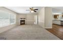 Inviting living room with a fireplace, ample natural light, and an open layout connecting to the kitchen at 261 Lakeview Dr, Locust Grove, GA 30248