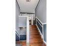 View of the home's staircase featuring wood stairs, white railings, and gray walls at 227 River Trace Ct, Mcdonough, GA 30253