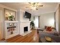 Cozy living room with a fireplace, built-in shelves, and hardwood floors at 997 Boulevard Se, Atlanta, GA 30312