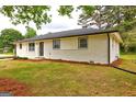 Charming, one-story home featuring a brick facade and complemented by well-maintained landscaping at 7279 Mayfair Cir, Jonesboro, GA 30236