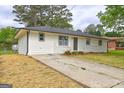 One-story home with brick details, a long driveway, and landscaping at 7279 Mayfair Cir, Jonesboro, GA 30236