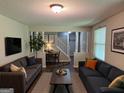 Inviting living room with neutral paint, lots of comfortable seating and natural light at 2691 Old South Dr, Jonesboro, GA 30236