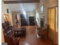 Spacious living room with hardwood floors, a fireplace, and ample natural light at 625 Locust Rd, Locust Grove, GA 30248