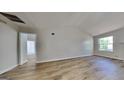 Bright living room featuring vaulted ceilings, wood-look flooring, and a large window at 11616 Spring Lake Way, Fayetteville, GA 30215