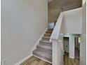 Carpeted staircase with white railing leading to the upper level of the home at 11616 Spring Lake Way, Fayetteville, GA 30215
