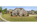 Charming single-Gathering home featuring stone accents, a manicured lawn, and a welcoming front porch at 2076 Towne Mill Ave, Canton, GA 30114
