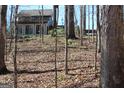 View of the exterior of the home surrounded by a natural woodland setting with mature trees at 460 Morgan Mill Rd, Brooks, GA 30205