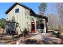 Charming home exterior with a fire pit and swing, perfect for enjoying the outdoors at 460 Morgan Mill Rd, Brooks, GA 30205