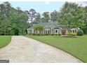 View of the lovely landscaped lawn and beautiful exterior of this home at 175 Thomas Overby Dr, Sharpsburg, GA 30277