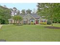Charming home featuring a well-maintained lawn and tastefully landscaped front yard at 175 Thomas Overby Dr, Sharpsburg, GA 30277