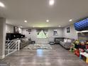 Spacious living room with modern flooring, cozy sofas, and a window providing natural light at 3456 Village Glen Ct, Snellville, GA 30039