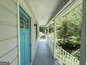 Inviting covered porch with white railings and a bright blue front door, offering a welcoming entrance at 3456 Village Glen Ct, Snellville, GA 30039
