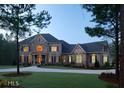 Beautiful stone home featuring manicured landscaping and inviting entryway during twilight hours at 315 Westbourne Dr, Tyrone, GA 30290