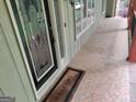 Close up view of the covered front porch entry with stained glass side windows at 205 Aberdeen Dr, Peachtree City, GA 30269