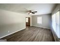 Sun-filled living room with modern floors, a ceiling fan, and fresh paint at 1417 Lavender Nw Dr, Atlanta, GA 30314