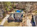 Aerial view of a brick home with a private backyard oasis and in-ground pool at 212 Birkhill, Peachtree City, GA 30269