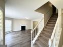 Spacious living room featuring wood floors, a fireplace and staircase at 2717 Knollberry Ln, Decatur, GA 30034