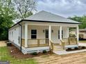 Beautiful home displaying a welcoming front porch and craftsman architectural details at 304 N Dogwood Ave, Social Circle, GA 30025