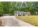 Charming single-story home with a stone facade and well-manicured lawn at 122 Hilo Rd, Fayetteville, GA 30215