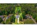 Aerial view of property showcasing the home nestled among lush greenery and a well maintained lawn at 120 Lyndhurst Way, Sharpsburg, GA 30277