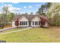 Inviting home with a well-kept lawn and neatly trimmed landscaping at 195 Blackberry Run, Fayetteville, GA 30214