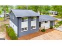 Aerial view of charming two-story home with updated windows, painted brick, and a well-manicured front yard at 410 Queen Aliese Ln, Jonesboro, GA 30236