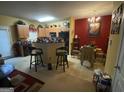 Eat-in kitchen features a breakfast bar, modern chandelier, and a dining set at 1255 Chinon Pt, Lithonia, GA 30058