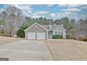 Lovely home featuring a two-car garage, stone facade, and well-kept landscaping, creating a welcoming curb appeal at 131 Meadowbrook Ln, Grantville, GA 30220