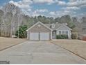 Charming home with stone accents, a two-car garage, and a well-maintained front yard on a sunny day at 131 Meadowbrook Ln, Grantville, GA 30220