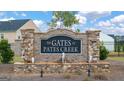 Stone entrance sign for The Gates at Pates Creek community with a fountain at 1817 Quaker St, Hampton, GA 30228