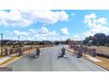 Gated community entrance showing the paved road and well-maintained landscaping at 1812 Quaker St, Hampton, GA 30228