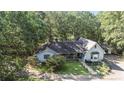 Aerial view of the home showcasing the well-manicured lawn, driveway, and surrounding trees at 2371 Leguin Mill Rd, Locust Grove, GA 30248