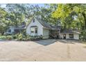 Exterior view of home with side entrance, partial driveway, and mature landscaping at 2371 Leguin Mill Rd, Locust Grove, GA 30248