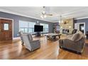 Spacious living room featuring hardwood floors, fireplace, and large windows at 2371 Leguin Mill Rd, Locust Grove, GA 30248