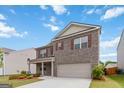 Well-maintained two-story brick home with a two-car garage and manicured lawn at 5396 Pennington Ct, South Fulton, GA 30349
