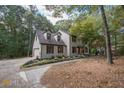 Two-story home with a brick facade, wood shutters, and mature trees at 185 Chimney Springs, Tyrone, GA 30290