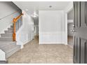 Welcoming foyer featuring tiled flooring, staircase, and access to other rooms in the home at 6322 Shell Sw Dr, Atlanta, GA 30331