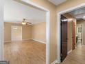 Open-concept living area featuring neutral walls, wood-look flooring, and an inviting view to dining and hall at 3 Ridge Dr, Hampton, GA 30228