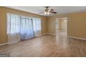 Bright living area with hardwood floors, ceiling fan, window coverings, and an open layout at 3 Ridge Dr, Hampton, GA 30228