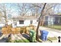 Cozy home featuring a fenced yard, a driveway, and front porch in a neighborhood at 1267 Lyle Nw Pl, Atlanta, GA 30318