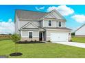 A beautiful home featuring a lush green lawn, complemented by brick accents and a two-car garage at 244 Oliver Dr, Locust Grove, GA 30248