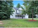 Beautiful two-story home with a covered front porch, a well-kept yard, and mature trees at 145 Tara Way, Covington, GA 30016