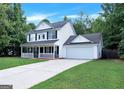 Attractive two-story home featuring an attached garage, driveway, and a neatly manicured lawn at 145 Tara Way, Covington, GA 30016