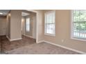 Bright living room featuring carpeted floors and a seamless transition to the tiled hallway at 145 Tara Way, Covington, GA 30016