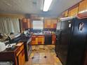 Cozy kitchen featuring multi-tone cabinets, black appliances, and tiled floors at 3244 Harbor Woods Rd, Decatur, GA 30034