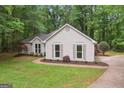 Charming home with neutral siding, complemented by well-maintained landscaping at 1000 Arbor Forest Sw Way # 1000, Marietta, GA 30064