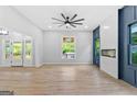 Bright, open-concept living room featuring hardwood floors, a fireplace, and a wall of large windows at 378 Grant Park Se Pl, Atlanta, GA 30315