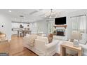 Bright living room with hardwood floors, a fireplace, and an open layout leading to the kitchen at 152 Creekrise Pl, Palmetto, GA 30268